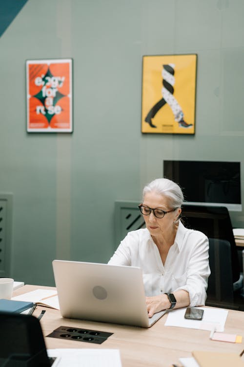 Free Elderly Woman Typing on Her Laptop Stock Photo