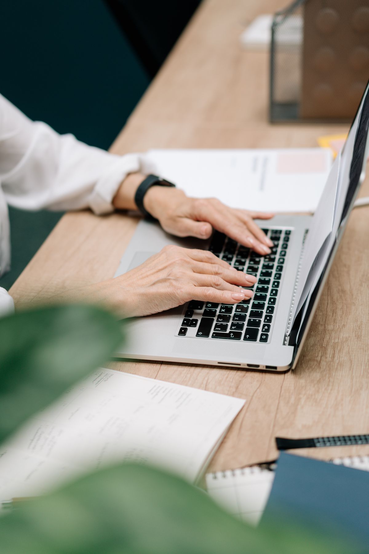 A person typing a document on a laptop, the starting point for converting Word to slides