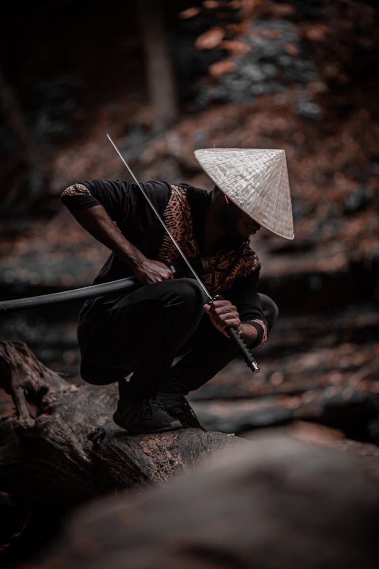 A Man Holding A Samurai