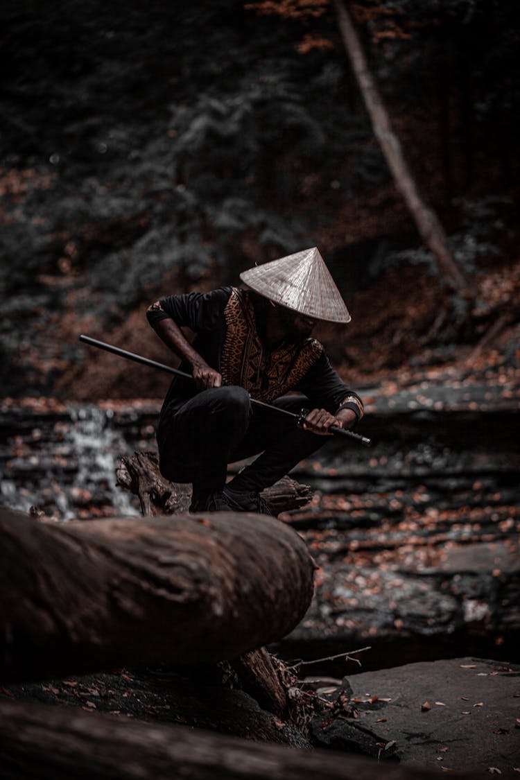 A Man Holding A Samurai