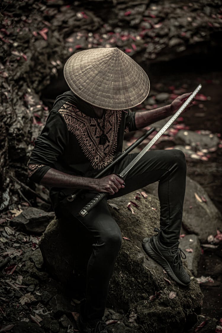 A Man Holding A Samurai