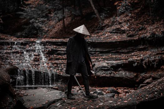 Person Wearing Straw Hat Holding a Sword