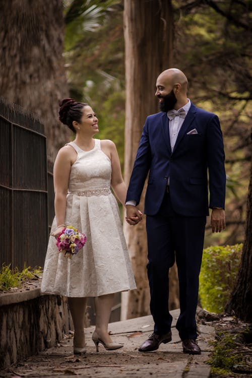 Couple Holding Hands While Walking