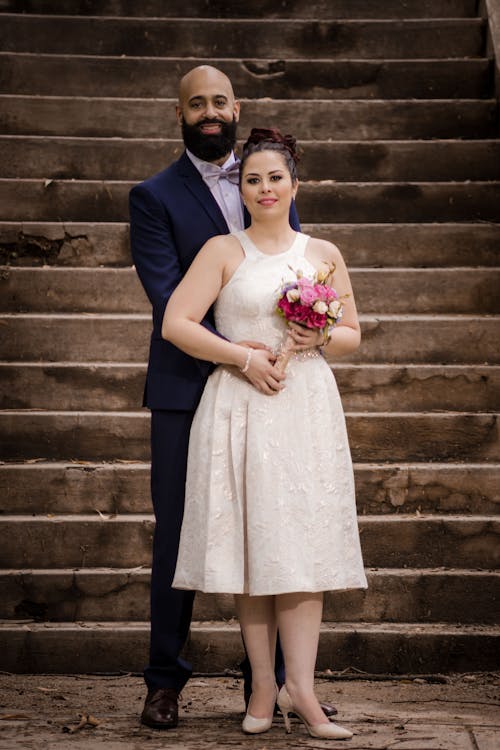 Married Couple Standing in Front of Stairs