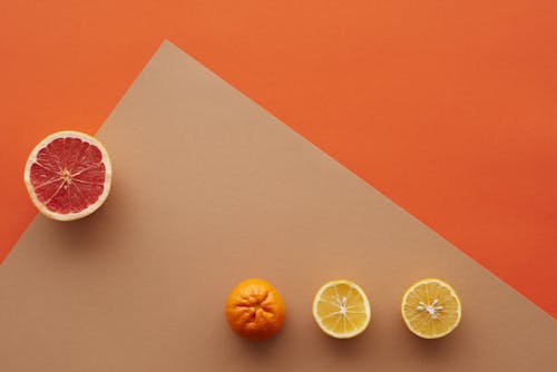 Sliced Fruits on Brown and Orange Background