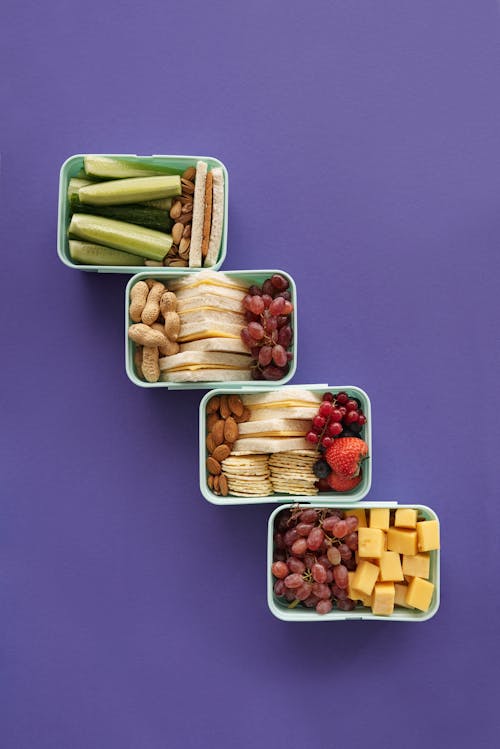 Free Food inside Green Food Containers on Purple Surface Stock Photo