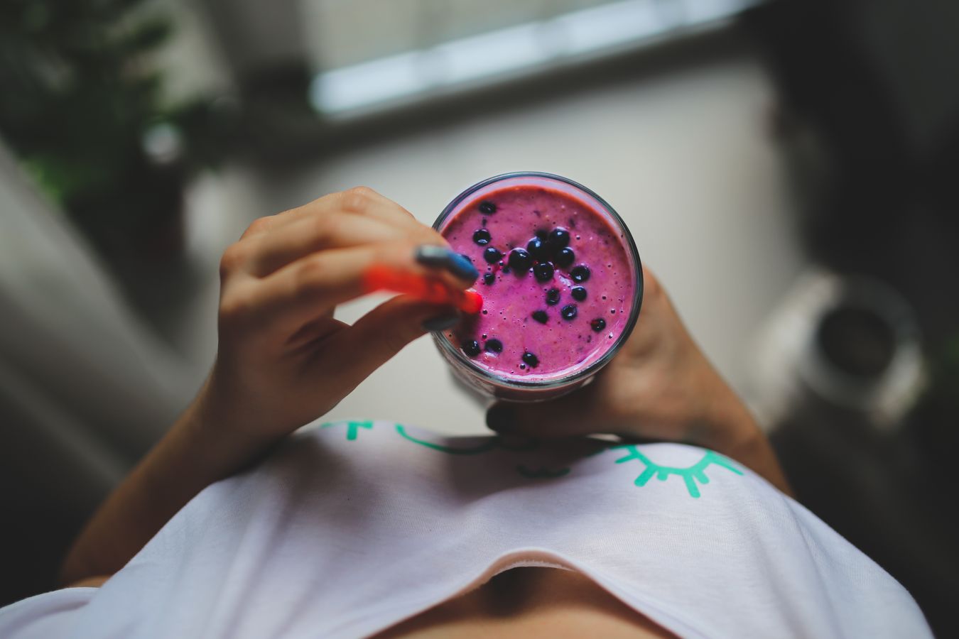 Person holding a yogurt-based smoothie as a lighter serving option