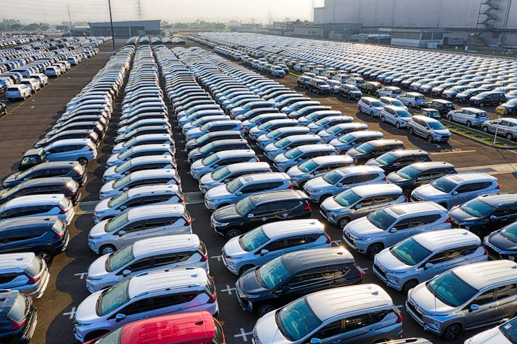 Rows Of Expensive Modern Cars On Asphalt Parking Of Manufacture