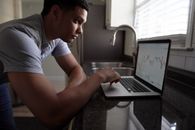 Man in Gray T-shirt Using Macbook Pro