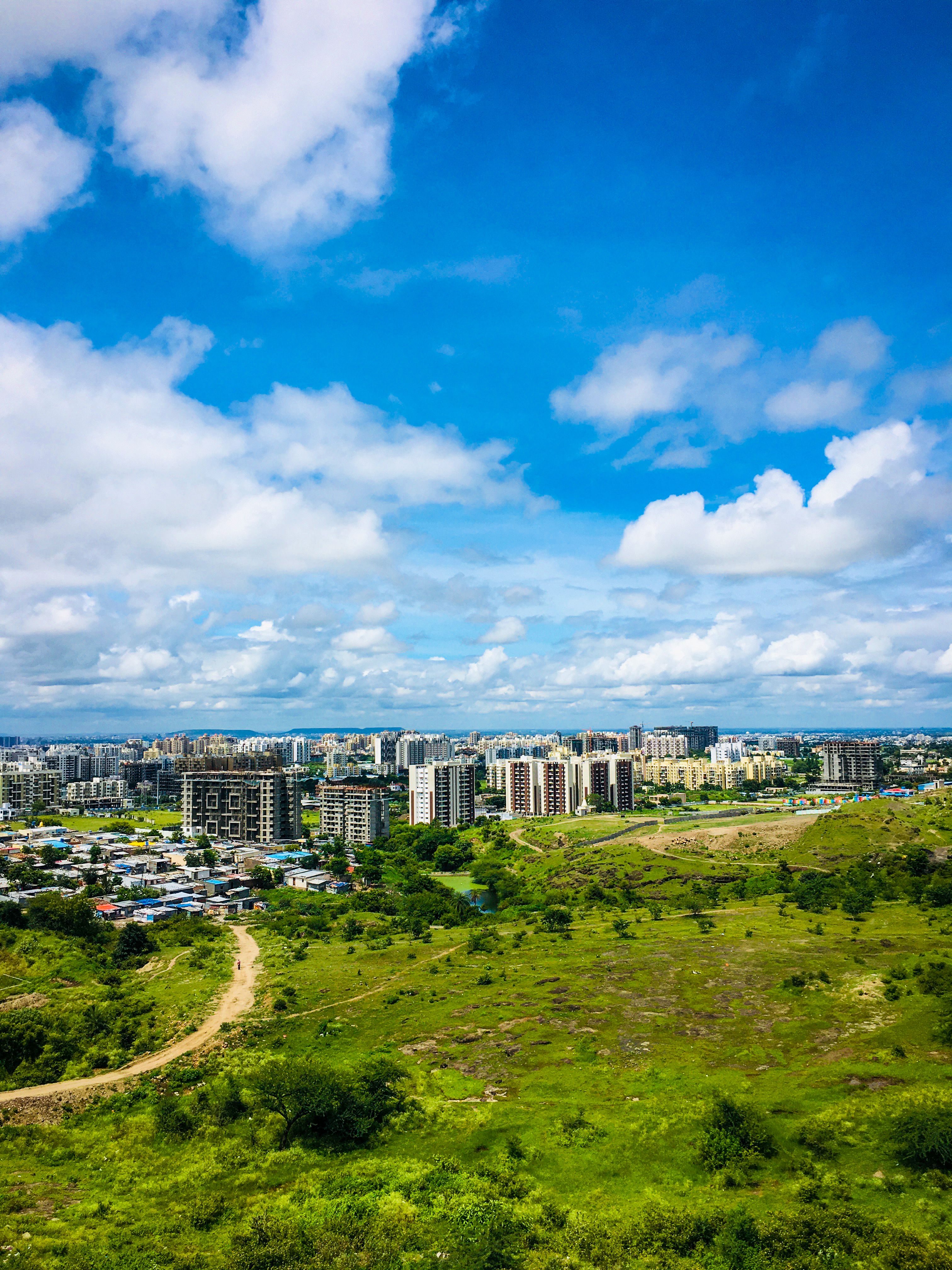 Aerial Photography of Buildings Under Blue Sky and Clouds · Free Stock ...