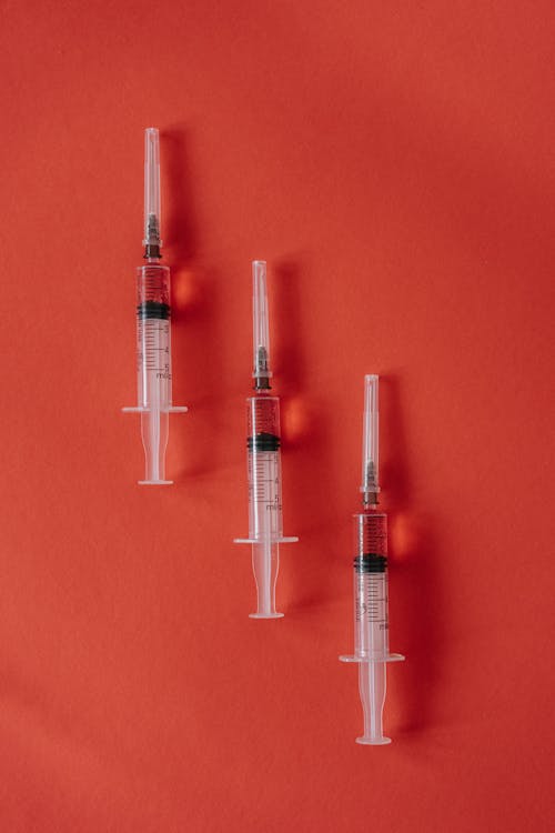 Syringes against Red Background