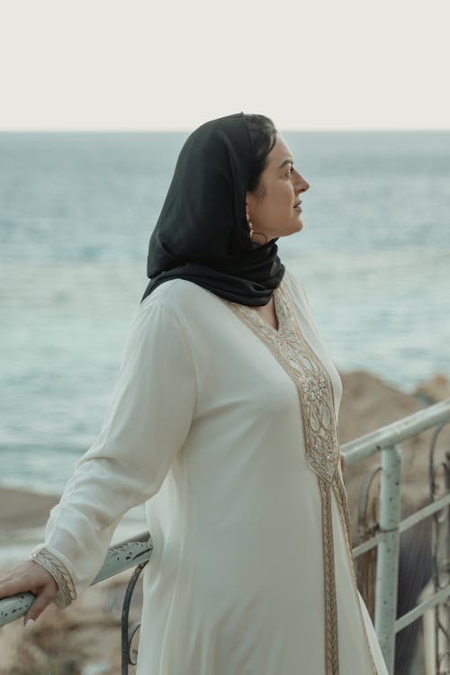 A Woman in a Hijab Leaning on a Railing