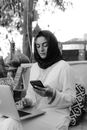 Woman in White Long Sleeve Shirt Holding Smartphone