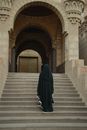 Woman in Black Dress Walking on Gray Concrete Staircase