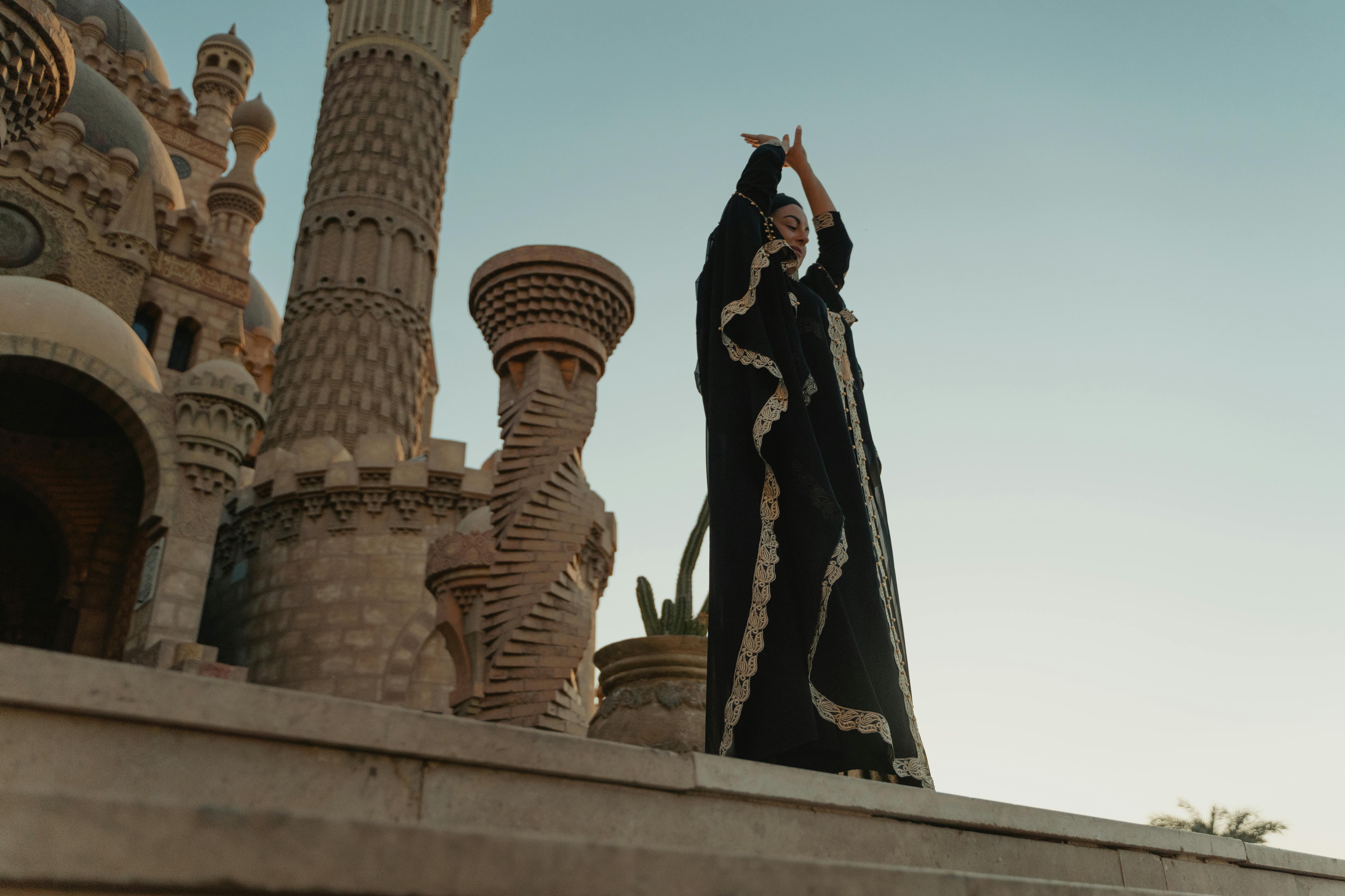 a woman wearing a black robe at a mosque