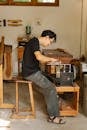 Focused ethnic artisan working at sharpening machine