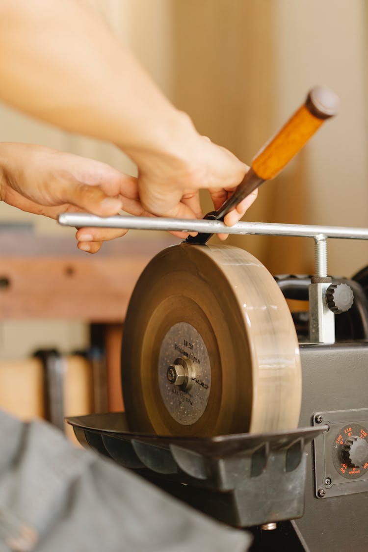 Crop Carpenter Sharpening Chisel In Workshop