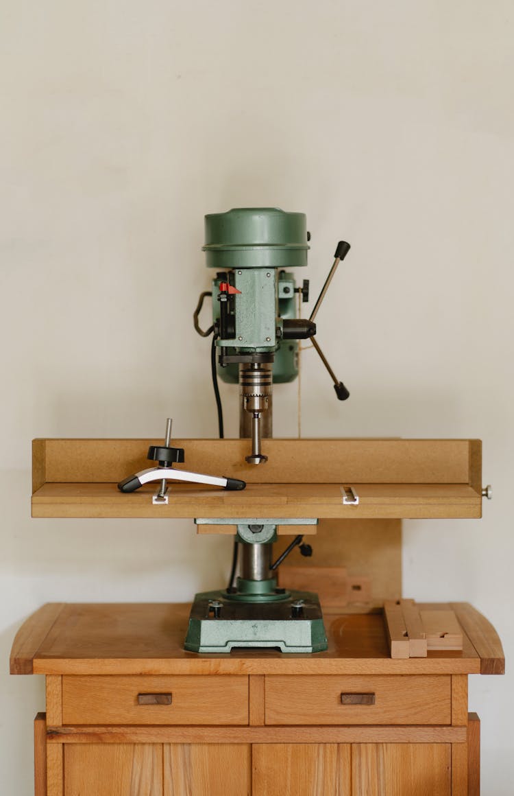 Drilling Machine On Wooden Table