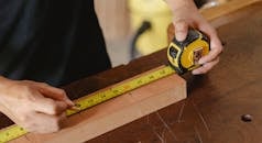 Crop man using ruler in workshop