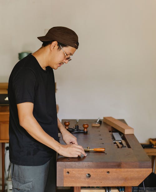 Focused ethnic artisan working in workshop