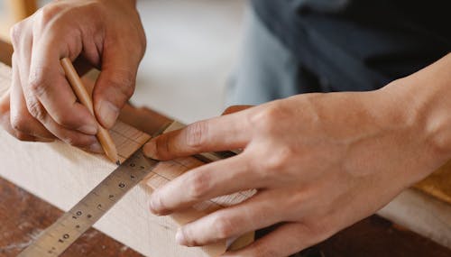 Man working with equipment on table in carpentry shop