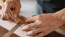 Man working with equipment on table in carpentry shop