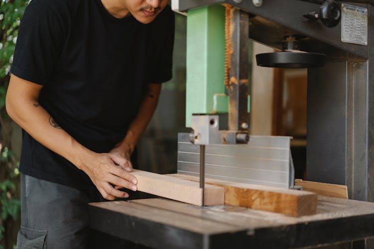 Crop Male Artisan Sawing Wooden Block With Band Saw