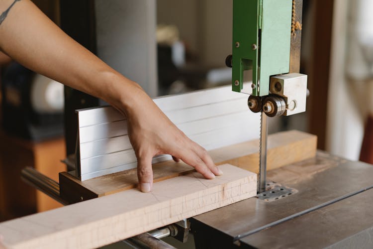 Faceless Woodworker Sawing Lumber With Band Saw