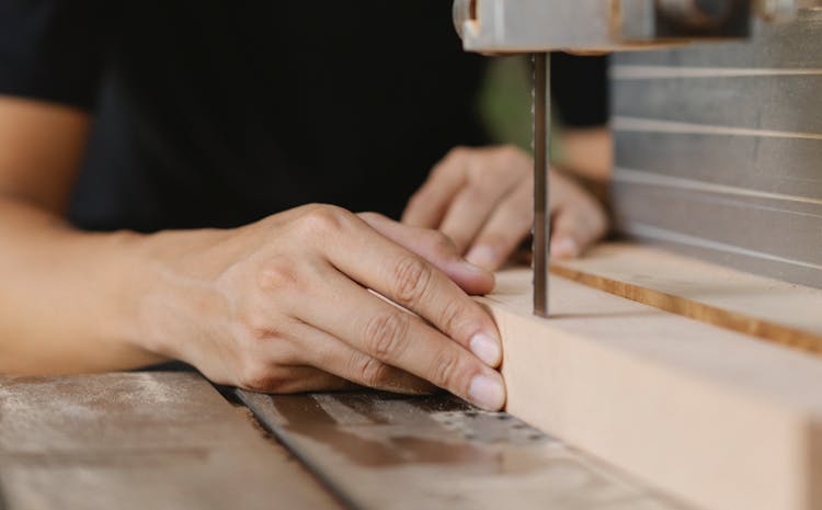 Faceless Joiner Cutting Timber With Band Saw On Table