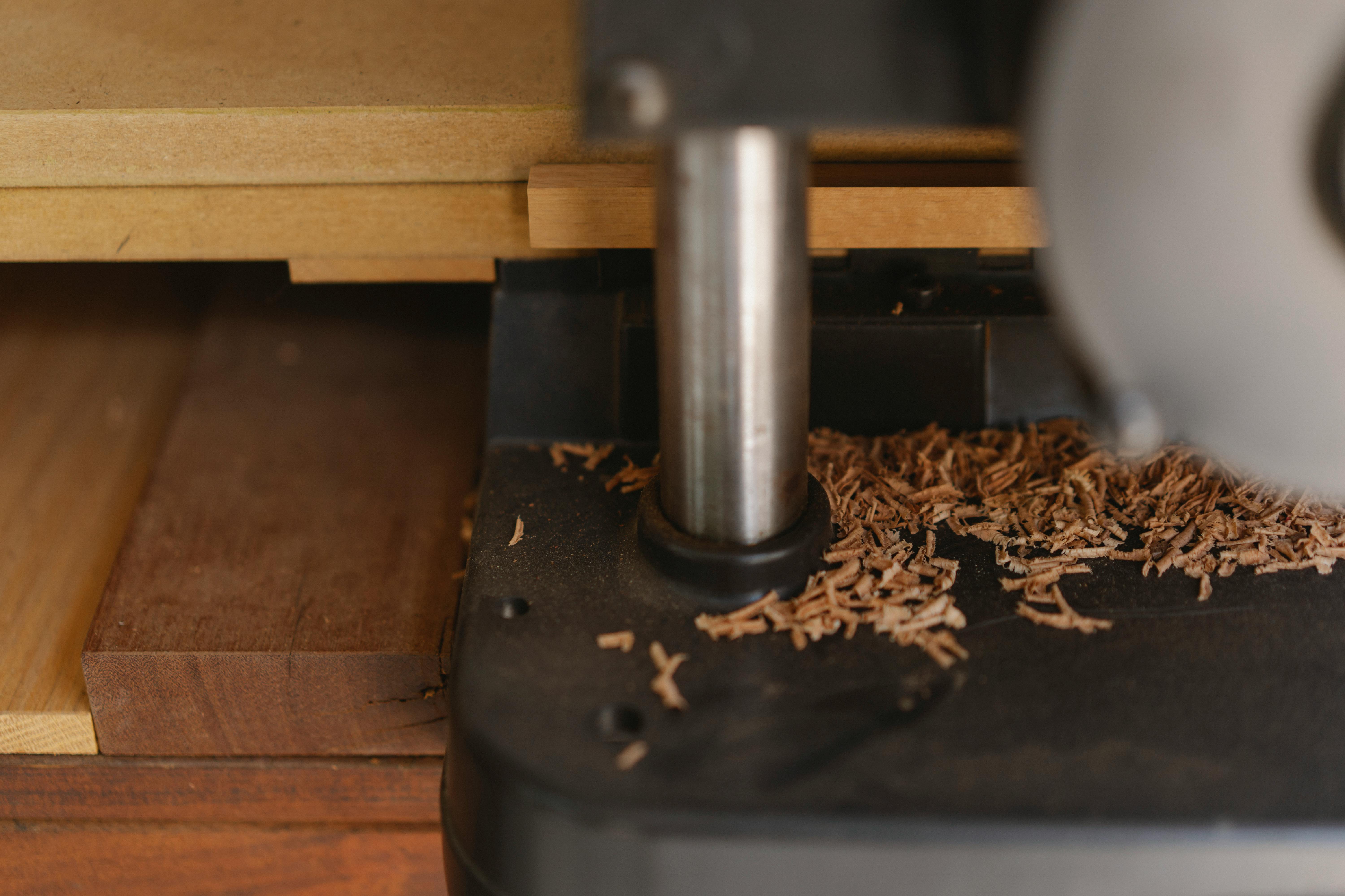 planer with wooden shavings on workbench in workshop