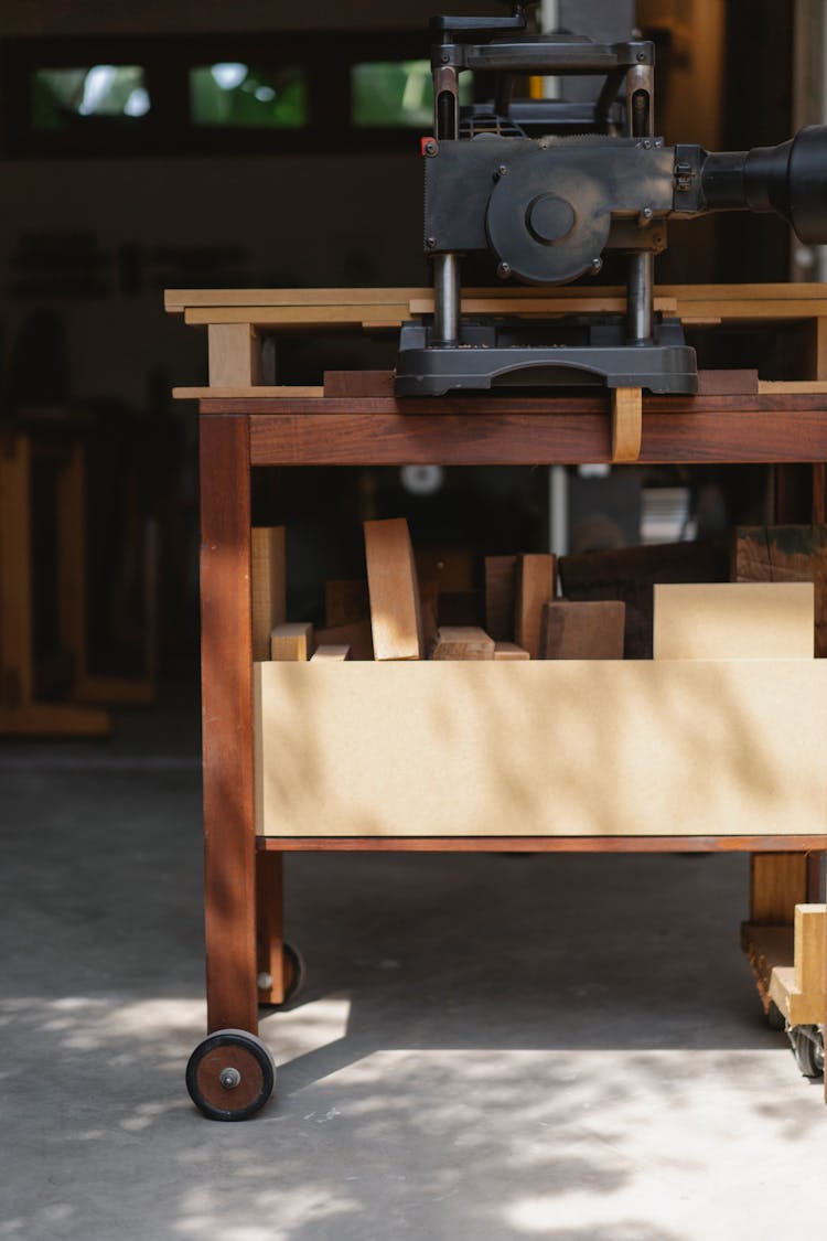 Planer On Wooden Workbench In Workshop In Sunlight