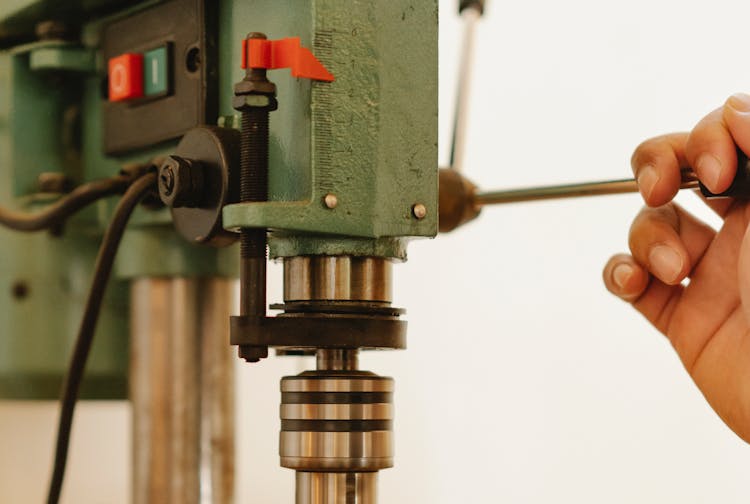 Crop Person Working With Drill Press