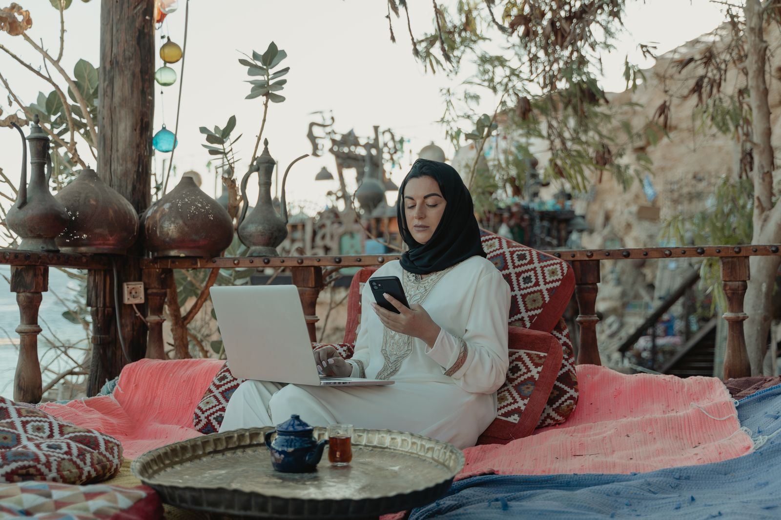 Investor working remotely with laptop and phone