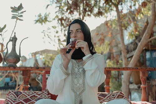 Woman Wearing Black Hijab And Drinking Tea