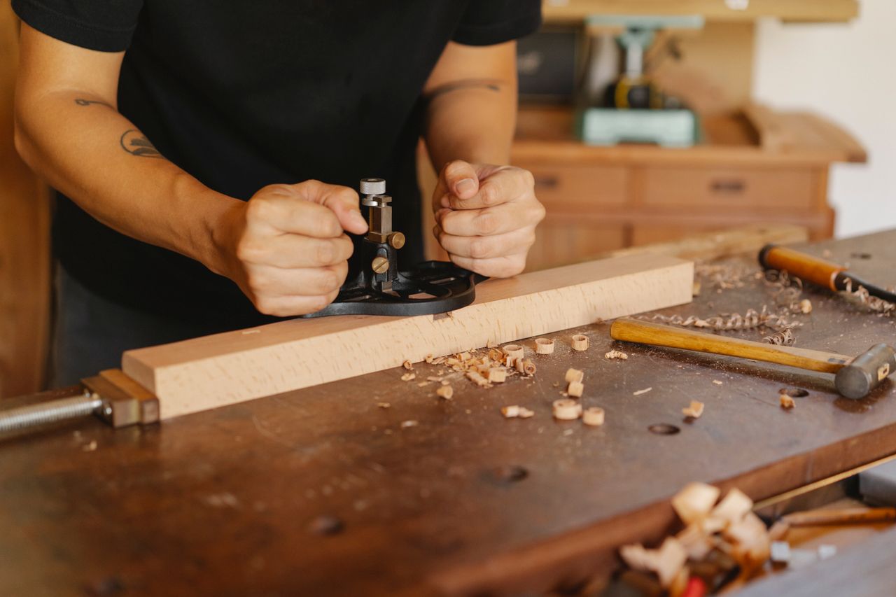 A cabinetmaker at a workbench in a timber workshop