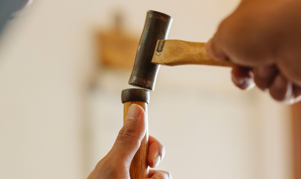 Carpenter working on wood furniture in a workshop
