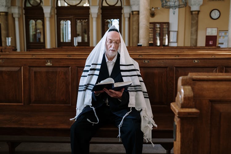 A Man In A Tallit Reading A Book