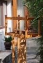 Small wooden bird feeder made with timber frames in garden outside house in summer