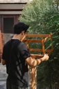 Carpenter working in garden with wooden detail