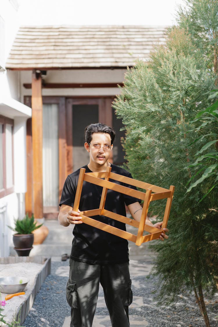 Serious Man With Timber Frame In Yard