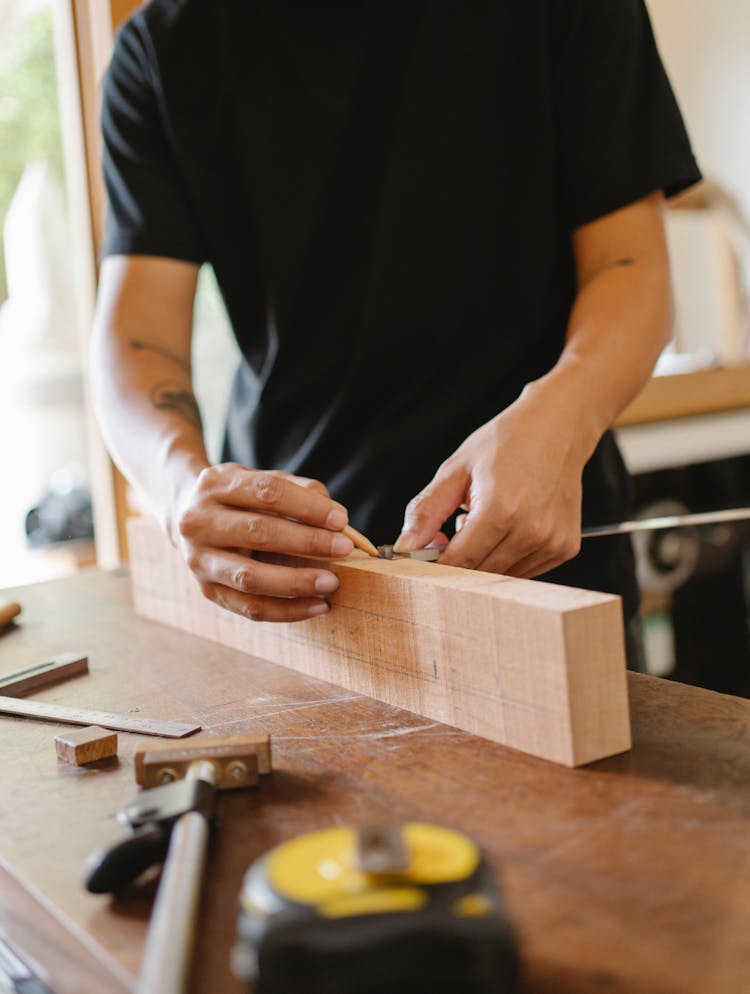 Crop Craftsman Making Sign On Wooden Plank