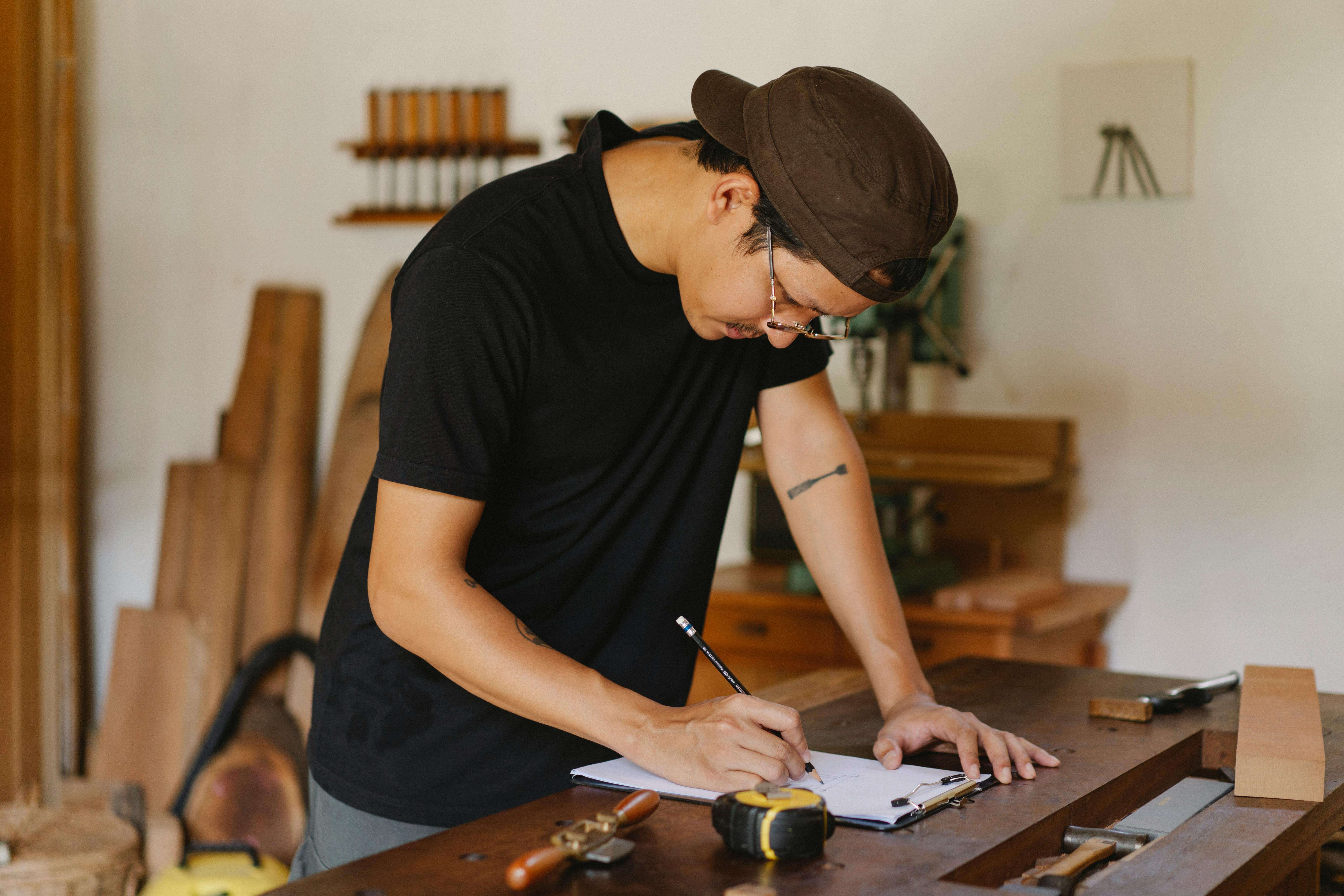 asian craftsman taking notes in joinery