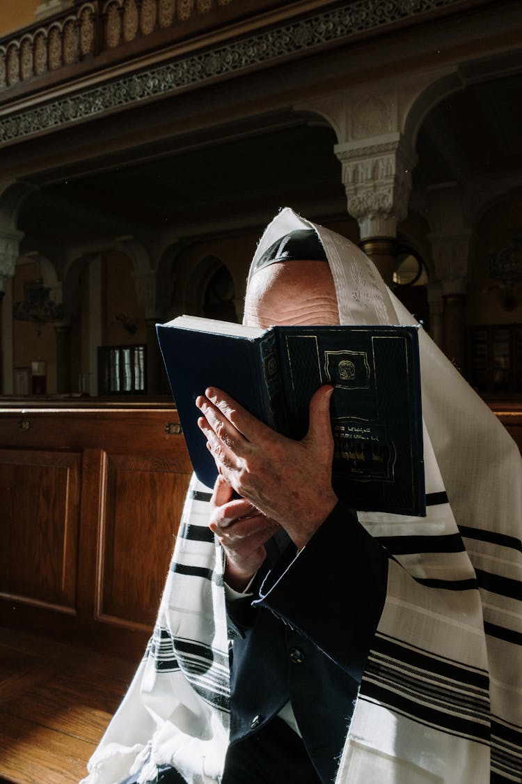 A Man In A Tallit Reading A Chumash