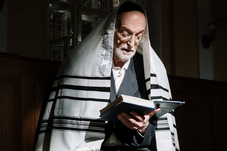 An Elderly Man Reading A Chumash