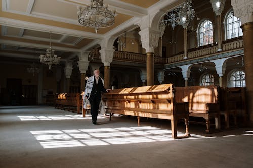 A Man Walking Inside a Church