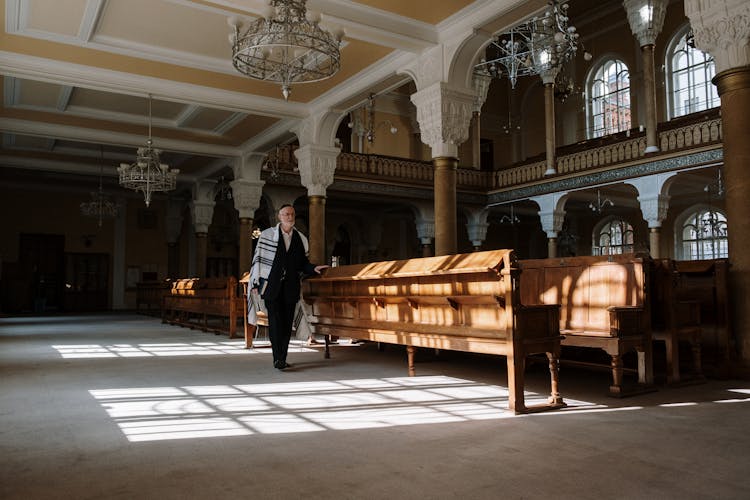 A Man Walking Inside A Church