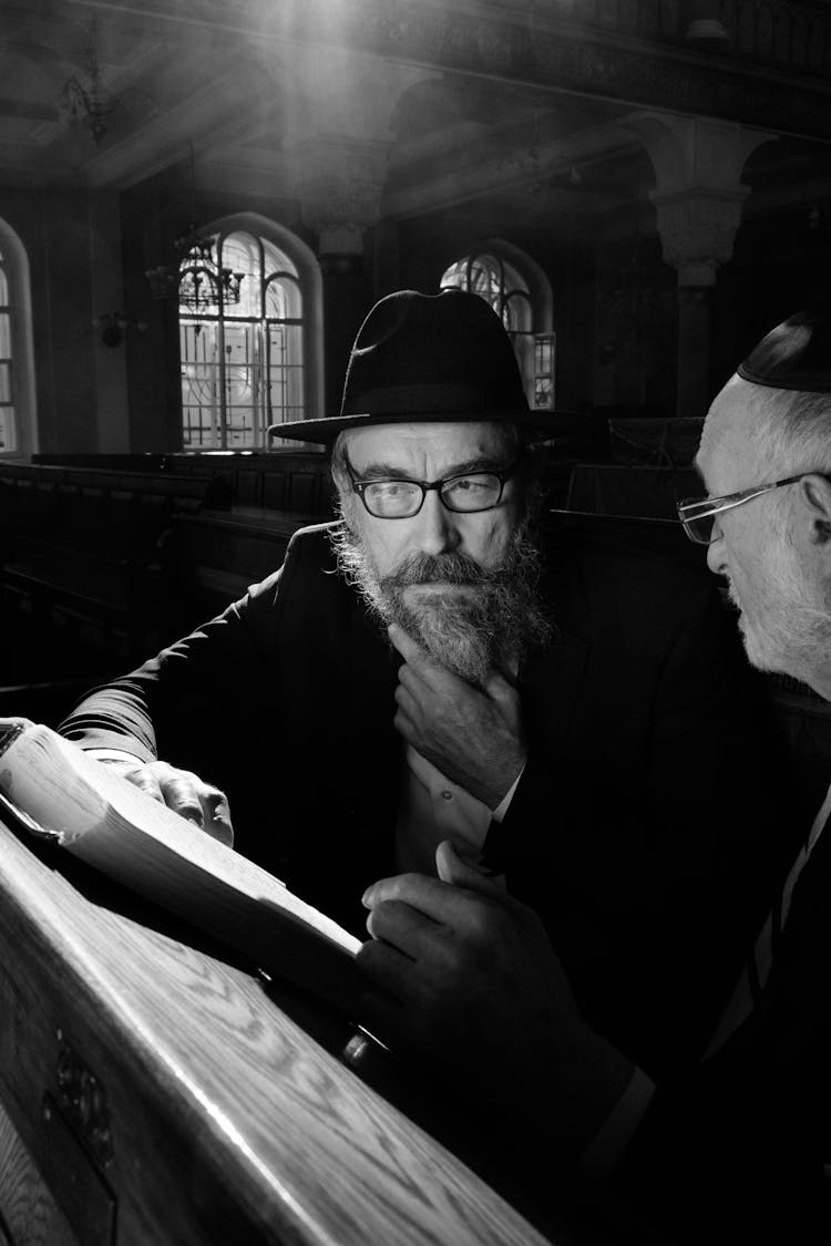 A Man Wearing Eyeglasses And Hat 