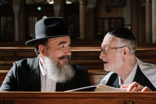 Men Sitting Looking at Each Other Smiling 