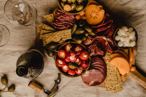 Free Luxurious charcuterie board with meats, cheeses, fruits, and wine, perfect for a gourmet dining experience. Stock Photo