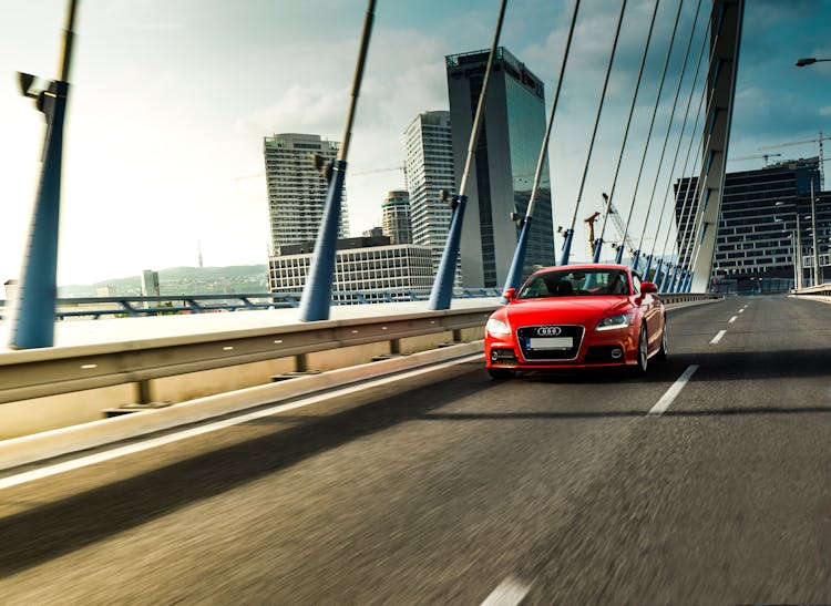 Red Sports Car On A Concrete Bridge